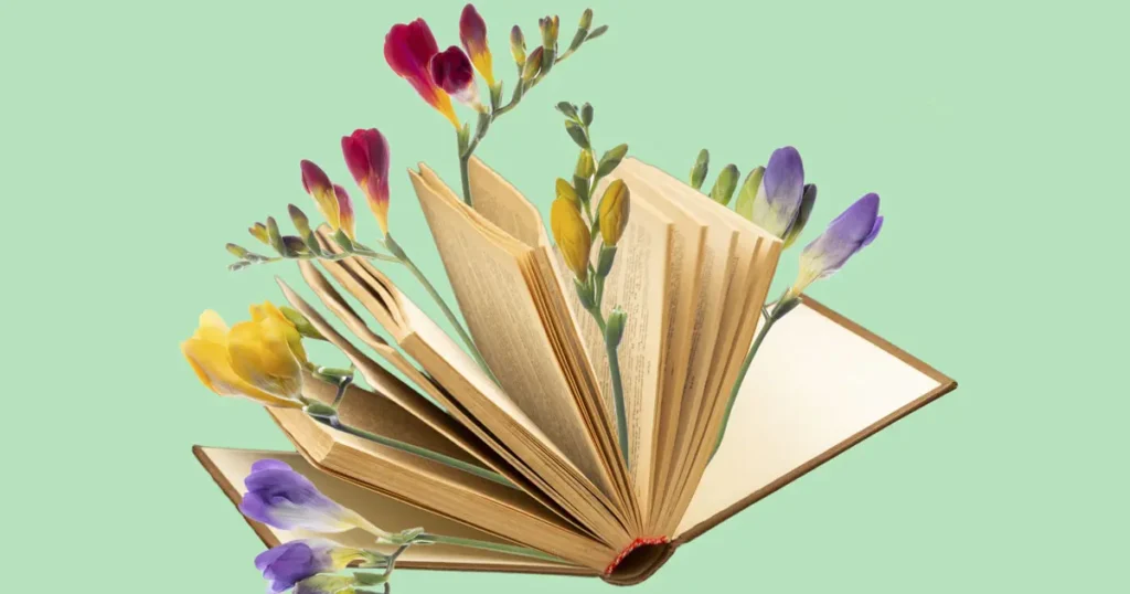 Open book with fanned out pages - has flowers growing in-between the leaves