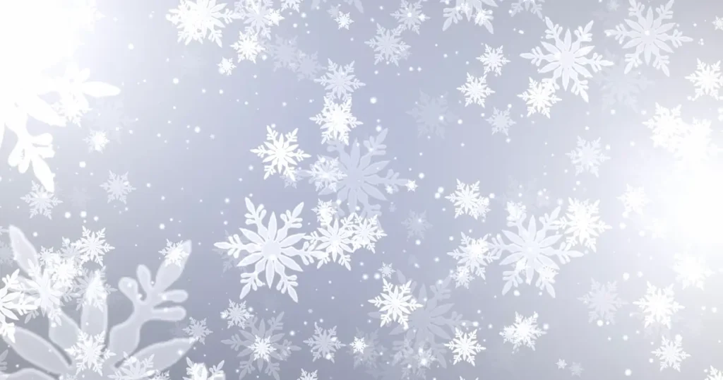 White snowflakes on a silver background for #designtips article A guide to posting social media over Christmas