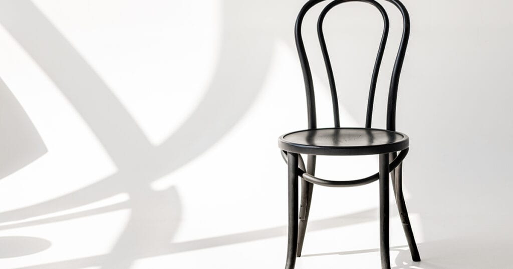 Thonet No. 14 bentwood chair in black on white background, demonstrating classic human-centred furniture design with curved wooden frame and cane seat. Photo by LightFieldStudios on Envato Elements